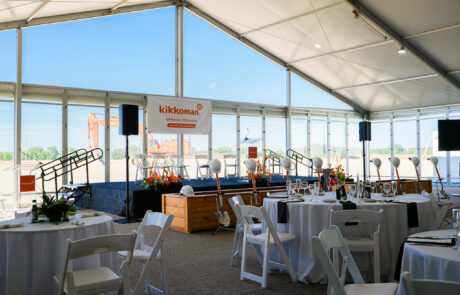 CRB Corporate groundbreaking in a massive structure tent with many connection. Stage front view in front of shovels.